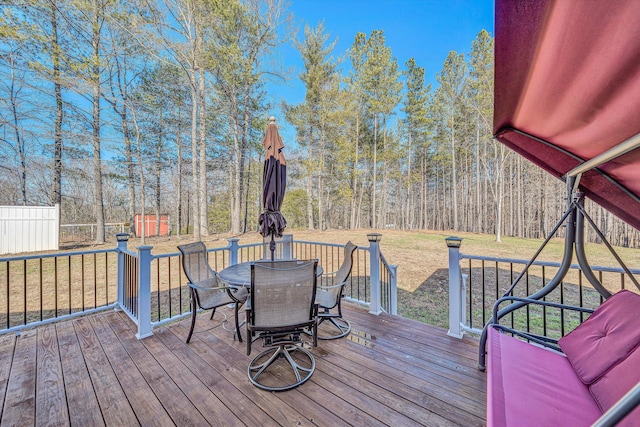 wooden deck with a lawn