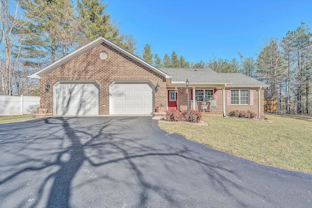 ranch-style house with a porch, a garage, and a front yard