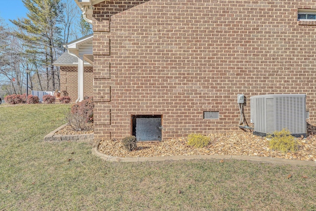 view of home's exterior with a yard and central AC