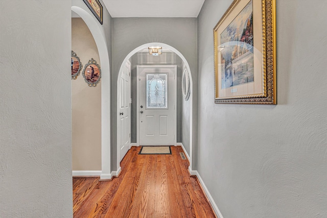 doorway to outside with wood-type flooring