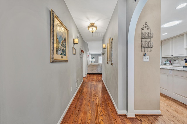 hallway with light hardwood / wood-style floors