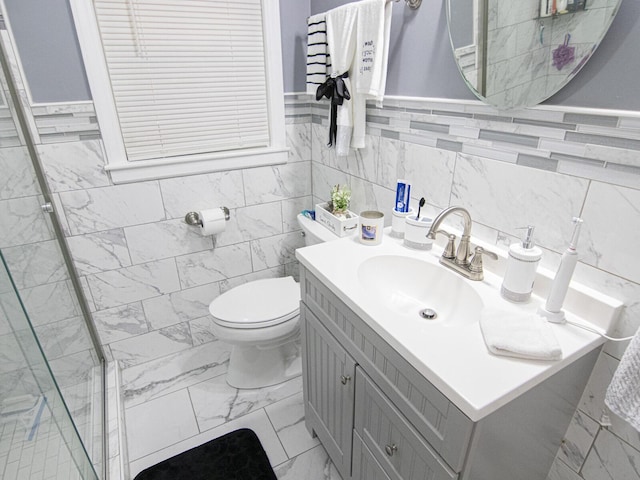 bathroom with vanity, toilet, and a shower with door