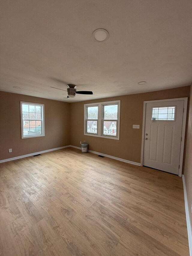 unfurnished bedroom with ceiling fan and light hardwood / wood-style flooring