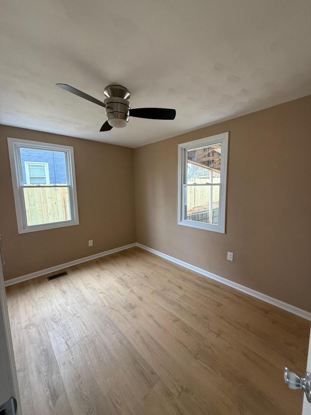 empty room featuring light hardwood / wood-style flooring and ceiling fan