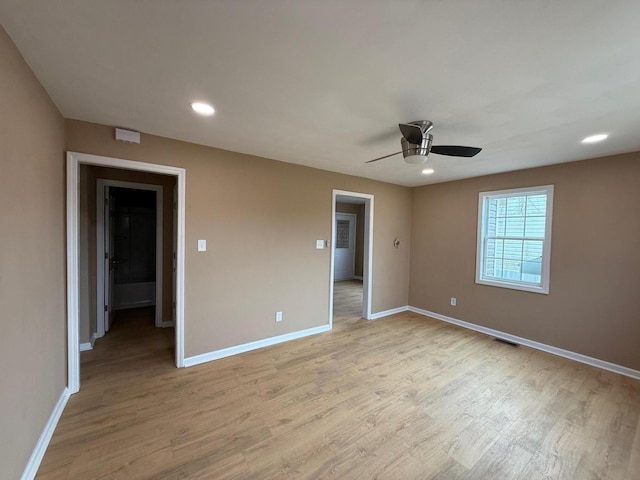 unfurnished room featuring light hardwood / wood-style floors and ceiling fan