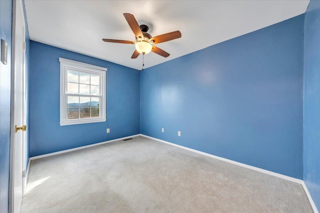 carpeted empty room with ceiling fan