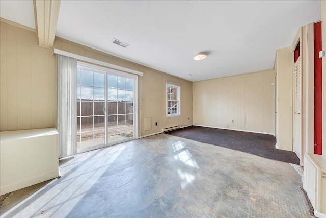 empty room featuring concrete floors and baseboard heating