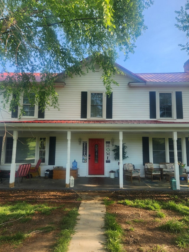 view of front of home with an outdoor hangout area, a porch, and metal roof