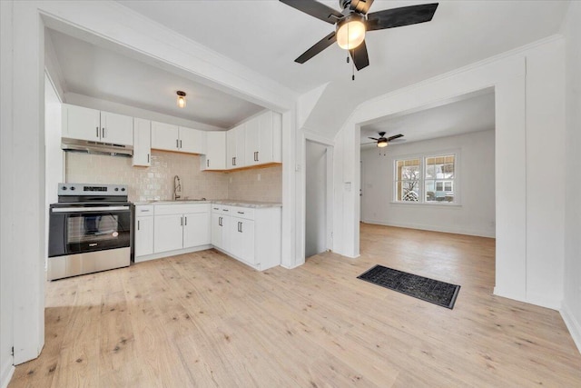 kitchen featuring light countertops, stainless steel electric range, white cabinetry, and under cabinet range hood