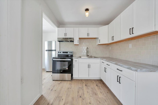 kitchen featuring appliances with stainless steel finishes, white cabinetry, a sink, and under cabinet range hood