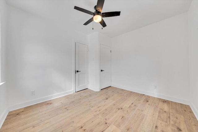 empty room with light wood-style flooring, baseboards, and ceiling fan