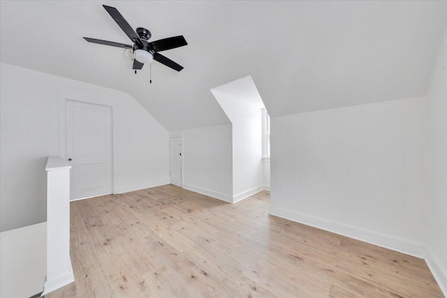 additional living space featuring vaulted ceiling, ceiling fan, light wood finished floors, and baseboards