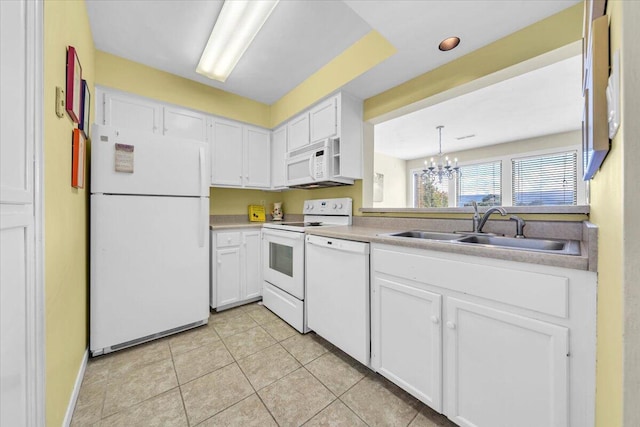 kitchen with sink, decorative light fixtures, a chandelier, white appliances, and white cabinets