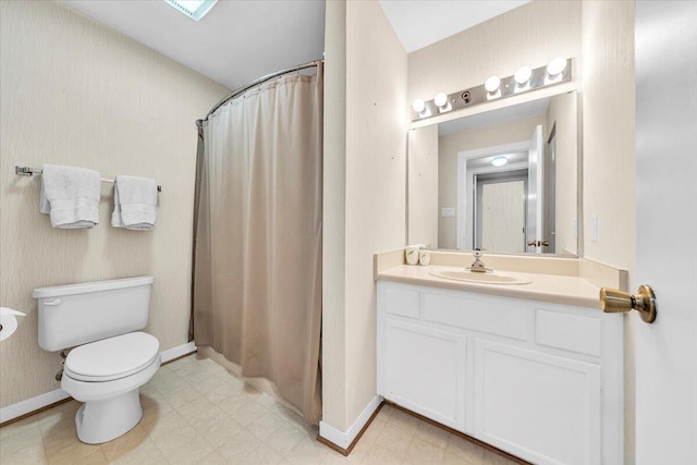 bathroom featuring vanity, toilet, and a shower with shower curtain