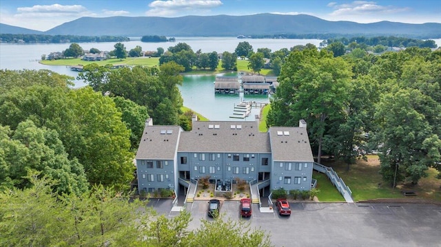 drone / aerial view featuring a water and mountain view