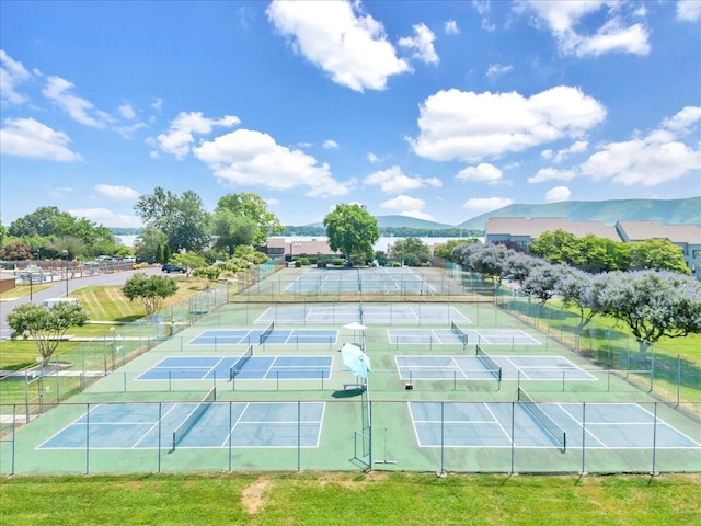 view of tennis court featuring a mountain view