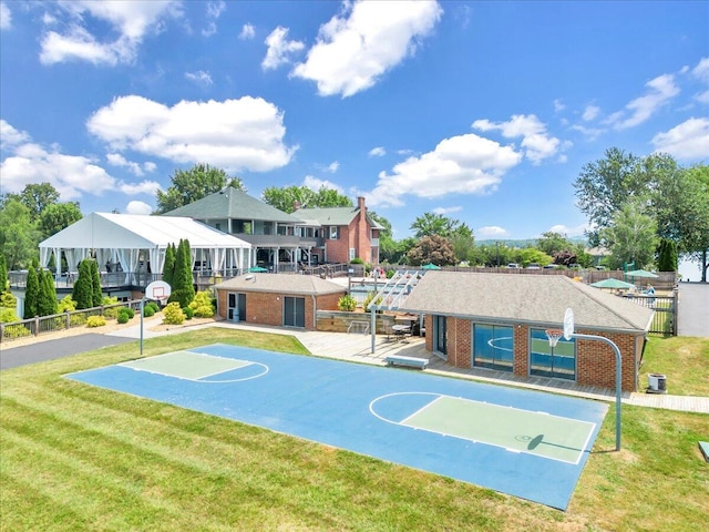 view of basketball court featuring a yard