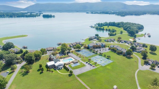 birds eye view of property with a water and mountain view