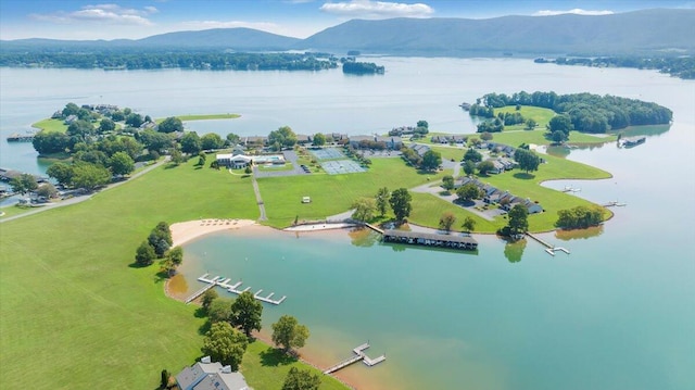 drone / aerial view featuring a water and mountain view