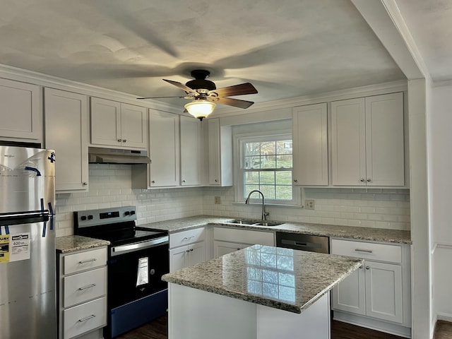 kitchen featuring white cabinetry, sink, a center island, and appliances with stainless steel finishes