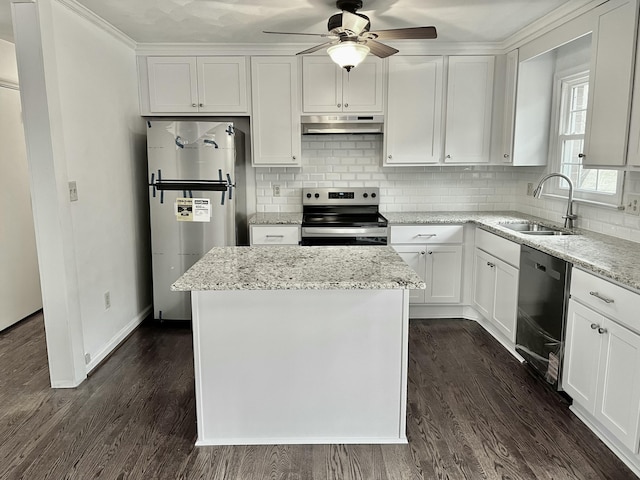 kitchen featuring sink, white cabinetry, a kitchen island, stainless steel appliances, and light stone countertops