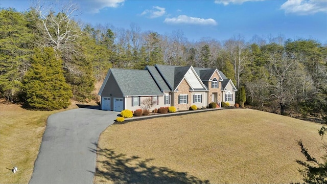 view of front of house featuring a garage and a front lawn