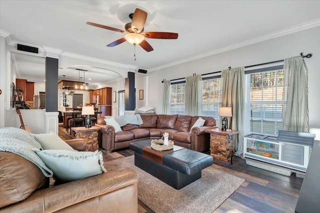 living room with ceiling fan, ornamental molding, and dark hardwood / wood-style floors