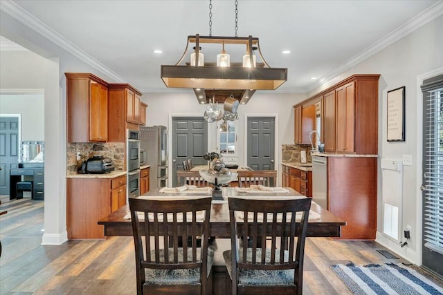 dining room featuring hardwood / wood-style flooring and ornamental molding