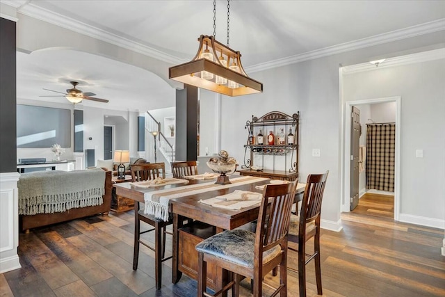 dining room featuring ornamental molding, ceiling fan, and dark hardwood / wood-style flooring