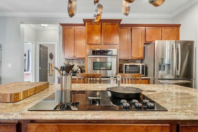 kitchen with backsplash, ornamental molding, light stone countertops, and appliances with stainless steel finishes