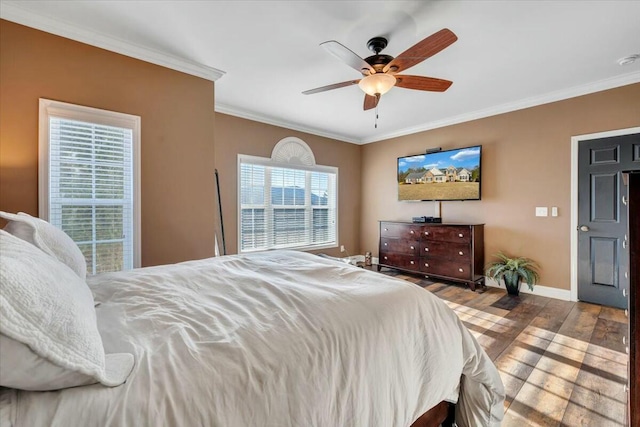 bedroom with ceiling fan, ornamental molding, and hardwood / wood-style floors