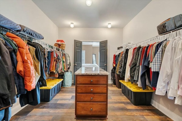 spacious closet with dark hardwood / wood-style floors