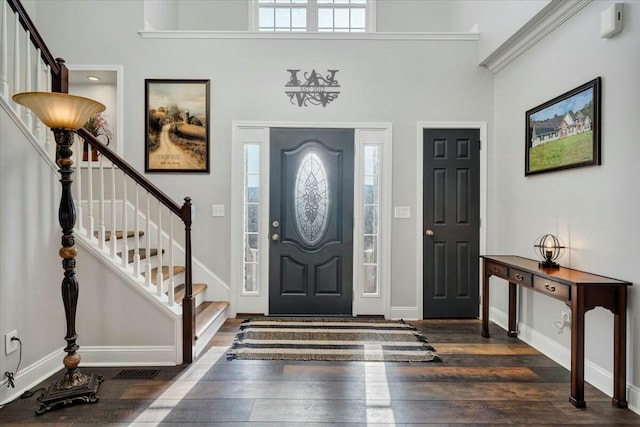 entryway featuring dark wood-type flooring and a high ceiling