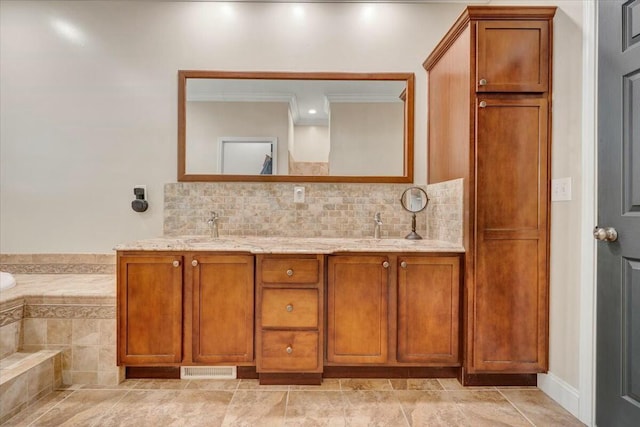 bathroom with backsplash, vanity, and tiled tub