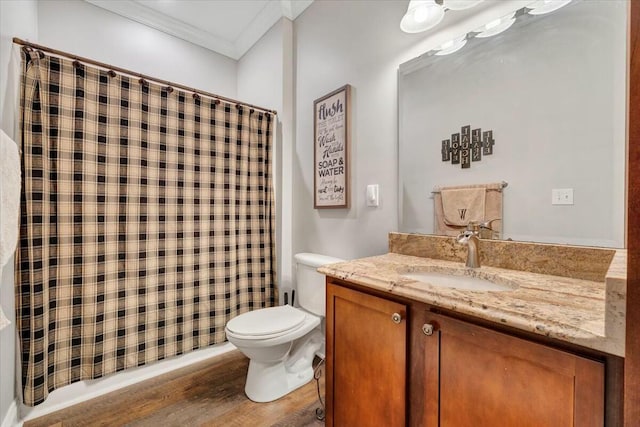 bathroom featuring vanity, hardwood / wood-style floors, crown molding, and toilet