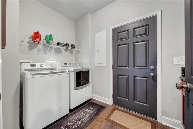 laundry room with dark hardwood / wood-style flooring, electric panel, and washer and dryer