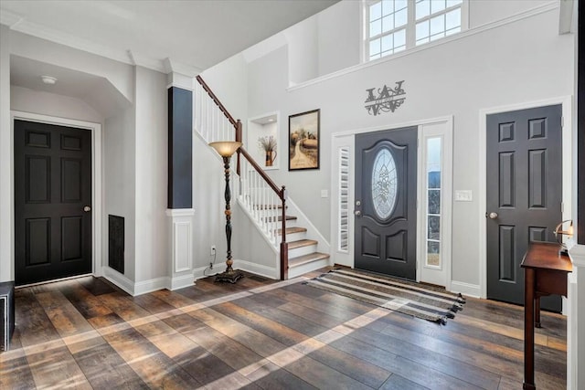 entryway featuring crown molding and dark hardwood / wood-style floors