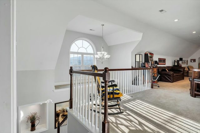 corridor featuring an inviting chandelier, carpet floors, and lofted ceiling