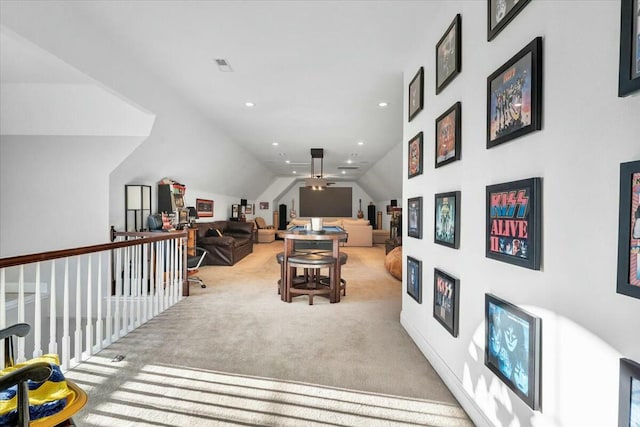 sitting room with lofted ceiling and light colored carpet