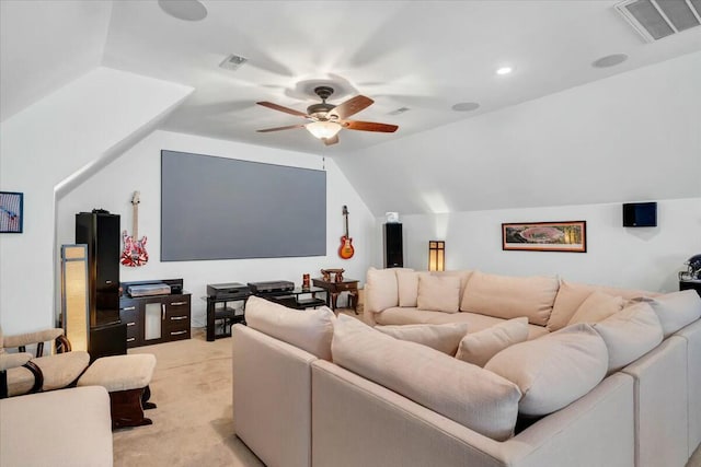 cinema room with lofted ceiling, light carpet, and ceiling fan