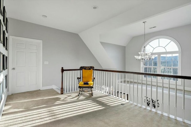 corridor featuring a notable chandelier, vaulted ceiling, and carpet flooring