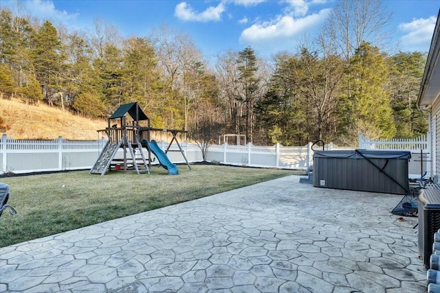 view of patio / terrace featuring a hot tub and a playground