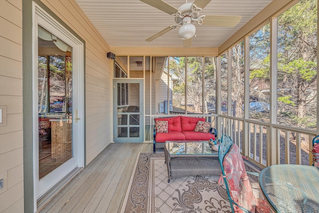 sunroom with plenty of natural light, outdoor lounge area, and a ceiling fan