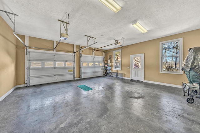 garage with baseboards and a garage door opener