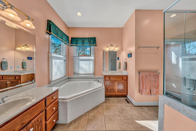 bathroom with plenty of natural light, a sink, a bath, and tile patterned flooring