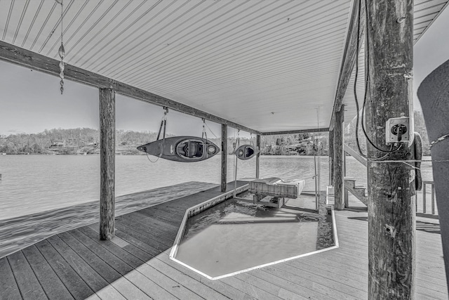 exterior space with a water view, a dock, and boat lift