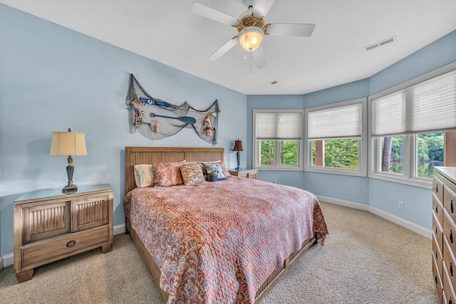 bedroom featuring a ceiling fan, baseboards, visible vents, and carpet