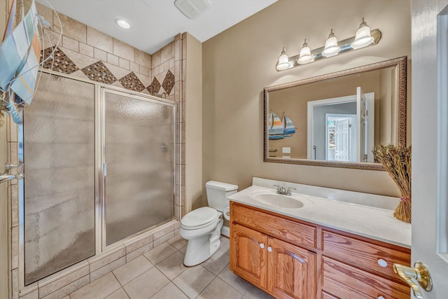 bathroom with vanity, a stall shower, tile patterned floors, and toilet