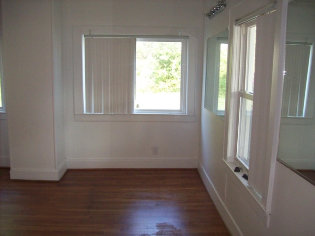 unfurnished room featuring dark wood-type flooring