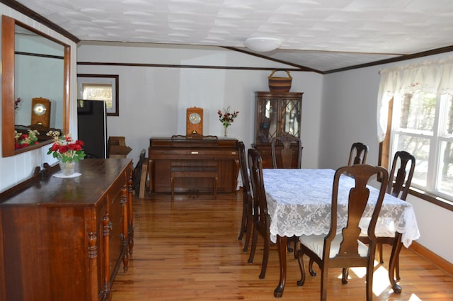 dining area featuring crown molding and wood finished floors